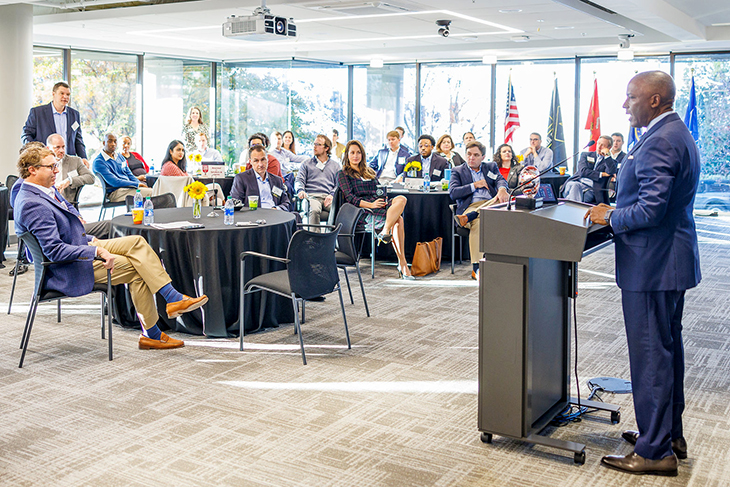 A male speaker talks to his audience from a podium during a Terry Third Thursday event.