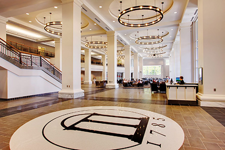 Large open Tate Student Center with Arch logo inlaid on floor