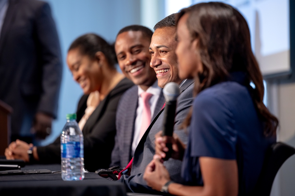 A panel of four speakers talk to their audience during a Terry Trailblazers event.