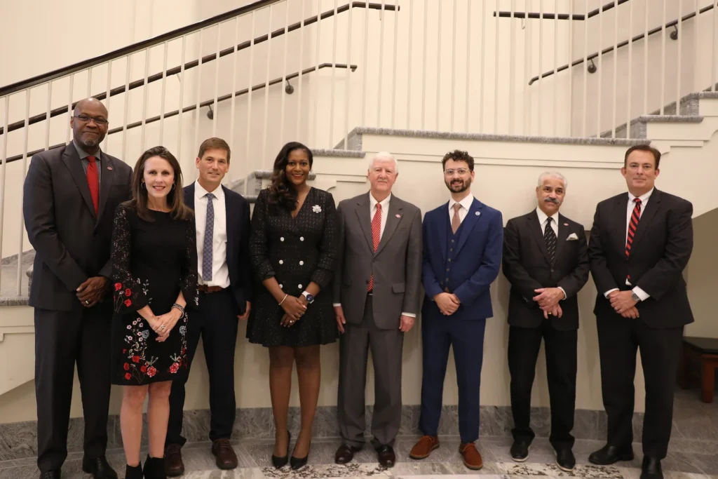 From left to right, Ron Walcott, Vice Provost for Graduate Education and Dean of the Graduate School; Catherine Bradshaw; Matthew Bonds; Adrienne Madison; Bob Izlar; Caleb Adams; Sangram Sisodia; Benjamin Ayers, Senior Vice President for Academic Affairs and Provost. (Photo by Nikki Mottley)