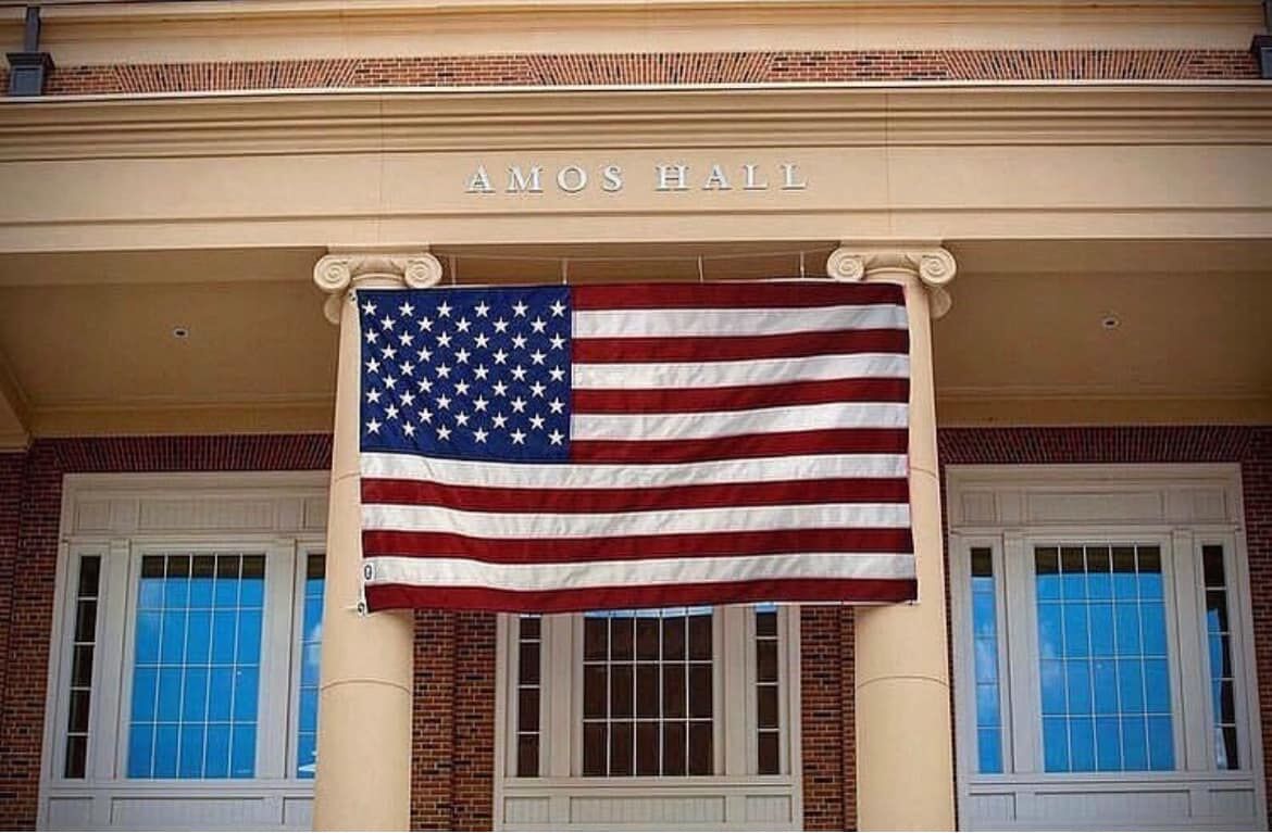 A American Flag i hung from the portico of Amos Hall at the University of Georgia Business Learning Community