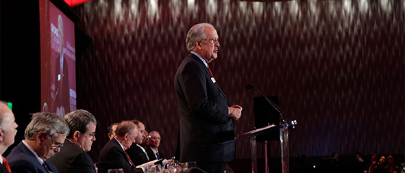 Man on stage speaking