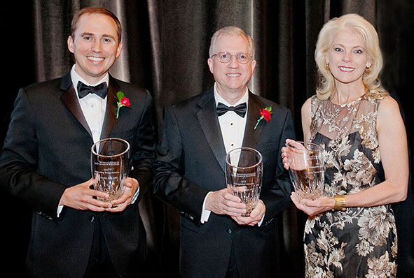 Terry College of Business Distinguished Alumni award winners poses for a photo with their awards.