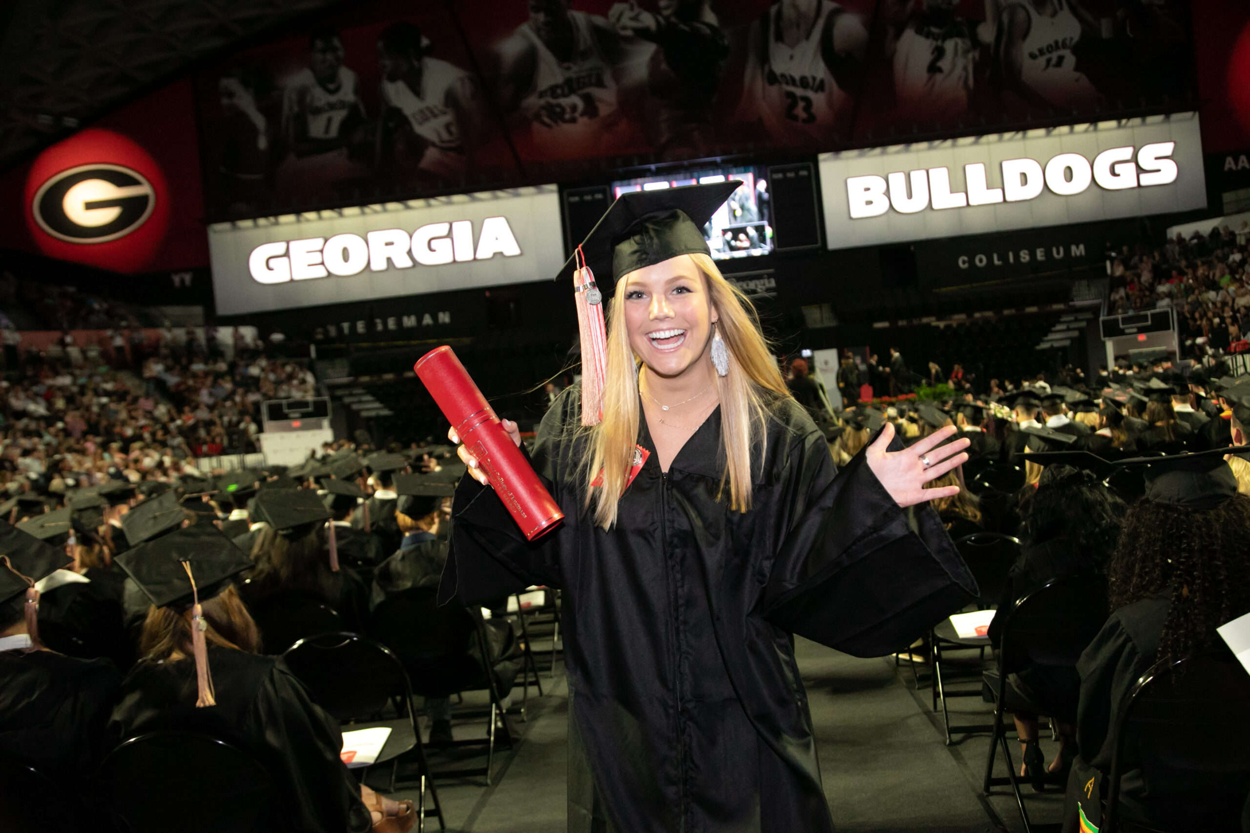 A Terry College graduate celebrates in her cap and gown during the 2019 undergraduate convocation