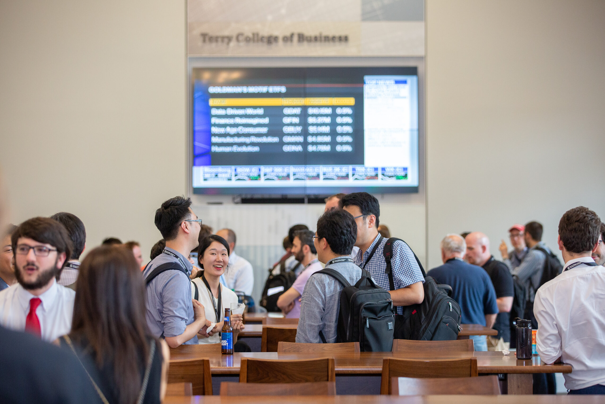 Terry students speak to each other during the 2019 Midwest Macroeconomics Meetings at the Terry Business Learning Community.