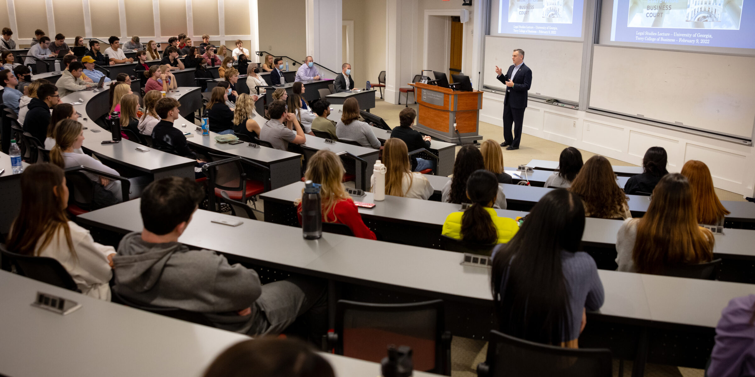 Professor teaching to a full room of students