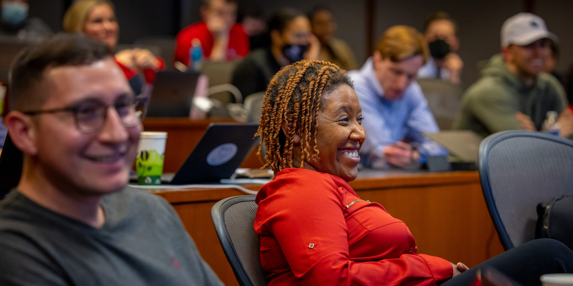 PMBA students smiling in class.