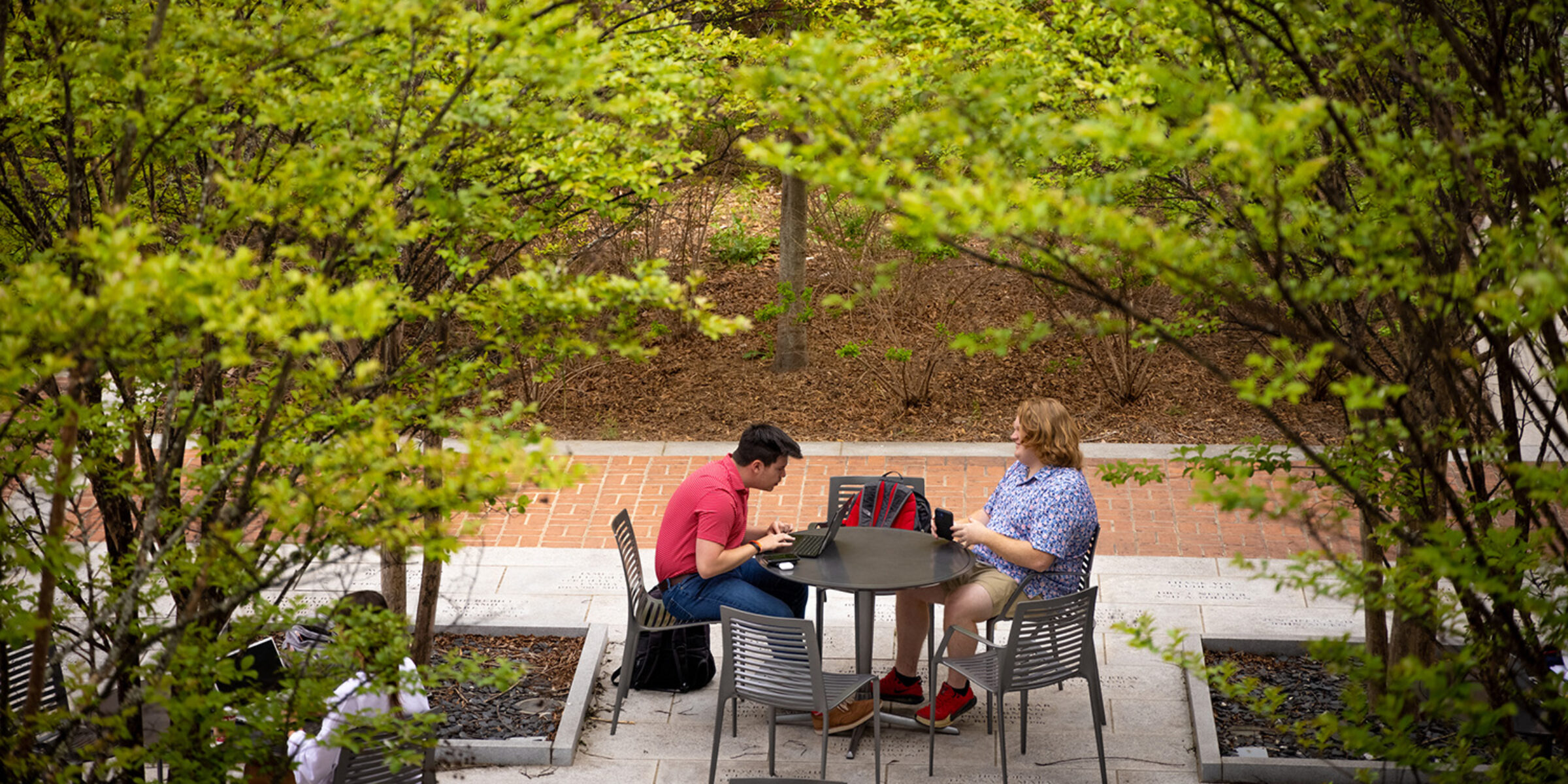 Two people at a table outside