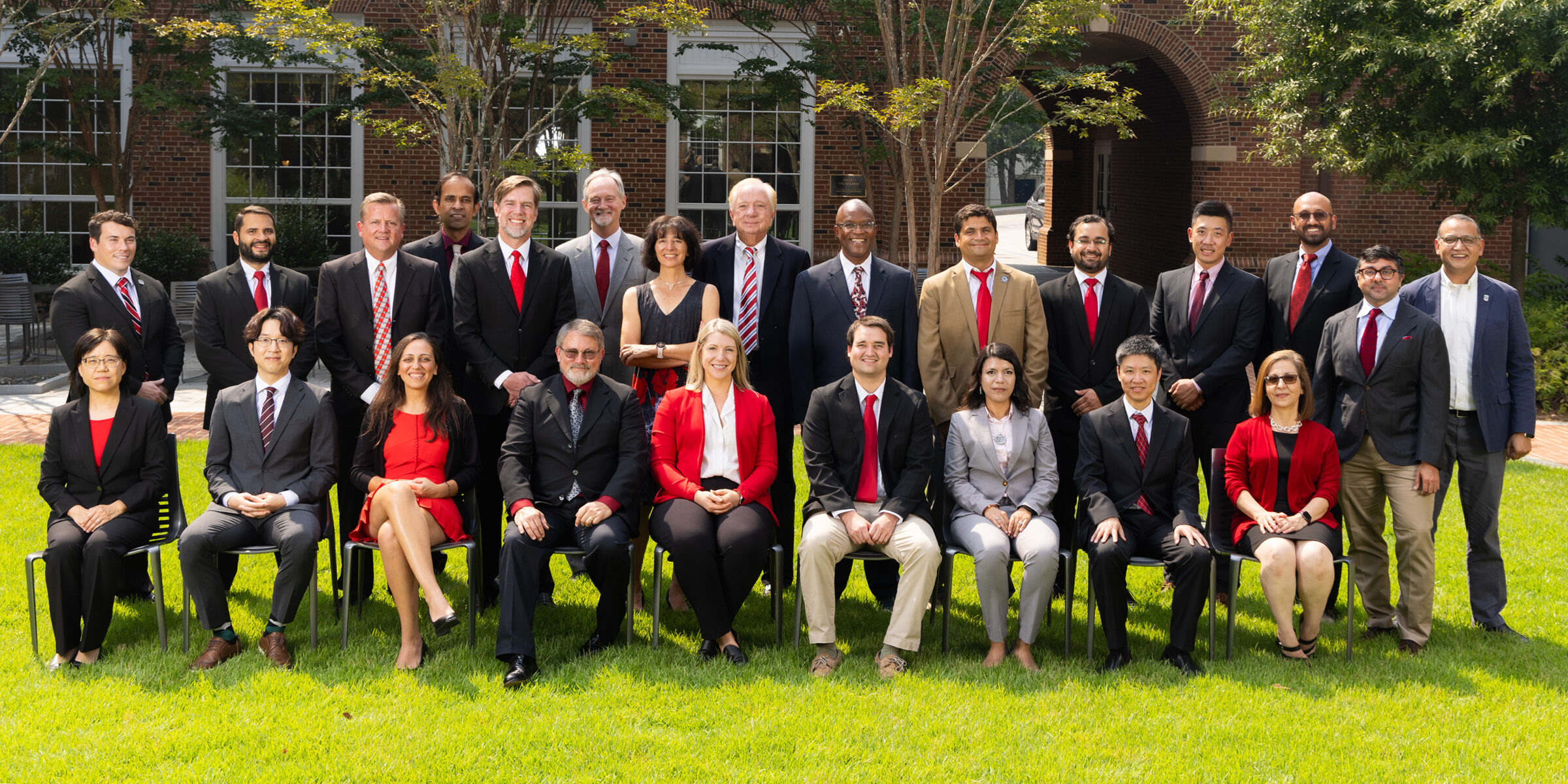 MIS faculty in business attire standing together for a picture.