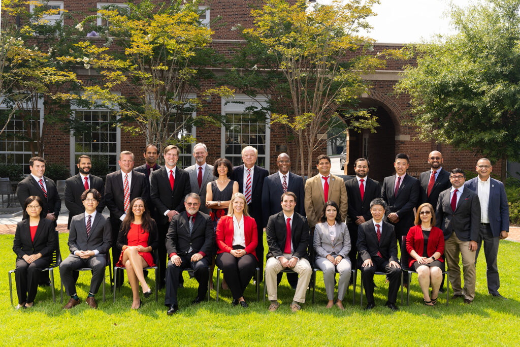 MIS Faculty in suits and ties posing for a group photo