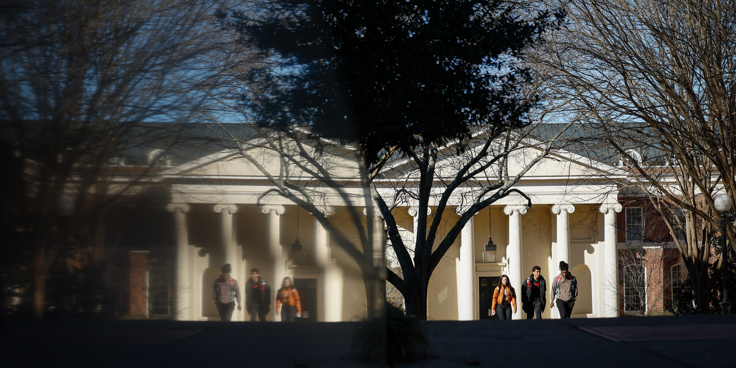 Student walks outside Brooks Hall on campus.