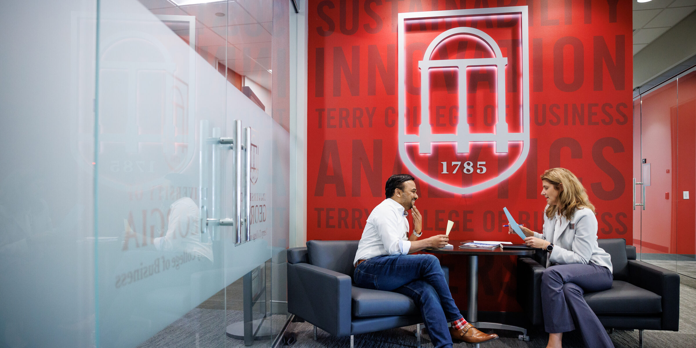 Two people sitting in chairs and chatting