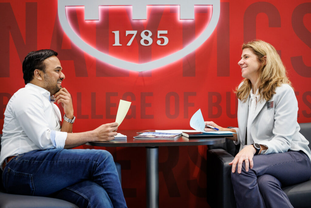 Two business professionals talking with each other at a table