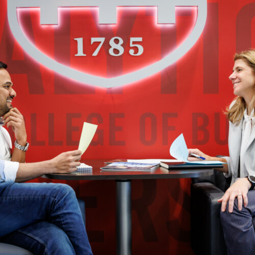 Two business professionals talking with each other at a table