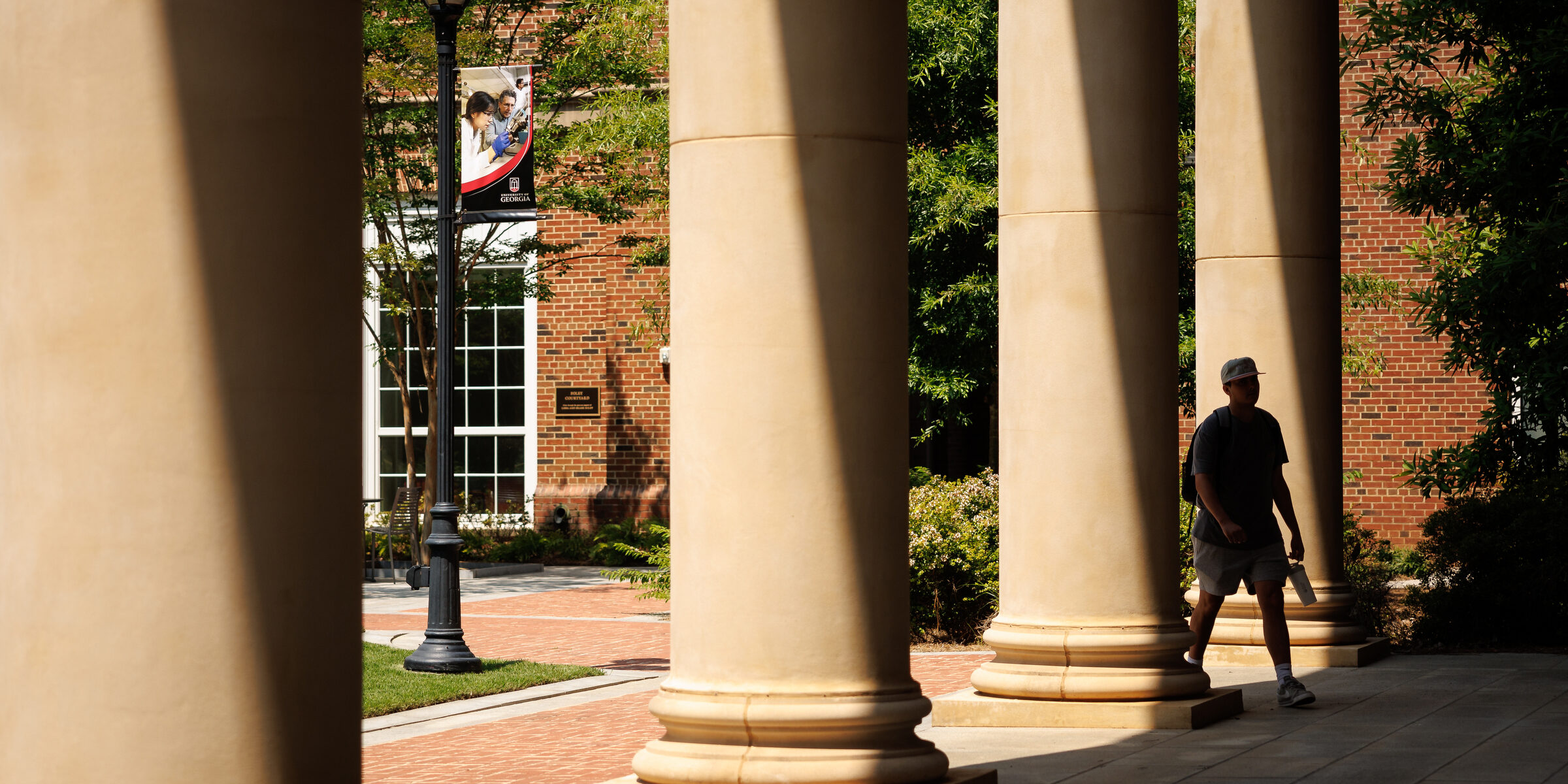 A student walking toward the ground floor entrance of Correll Hall.