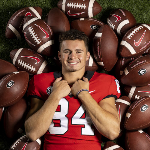 Ladd McConkey on a pile of footballs