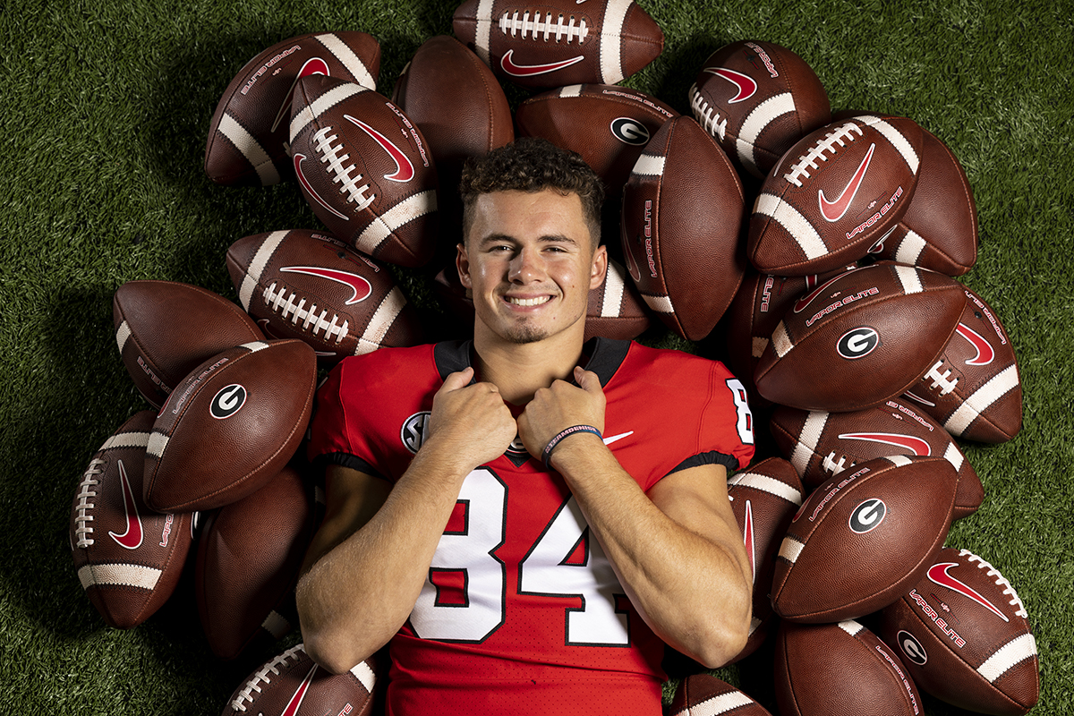 Ladd McConkey on a pile of footballs