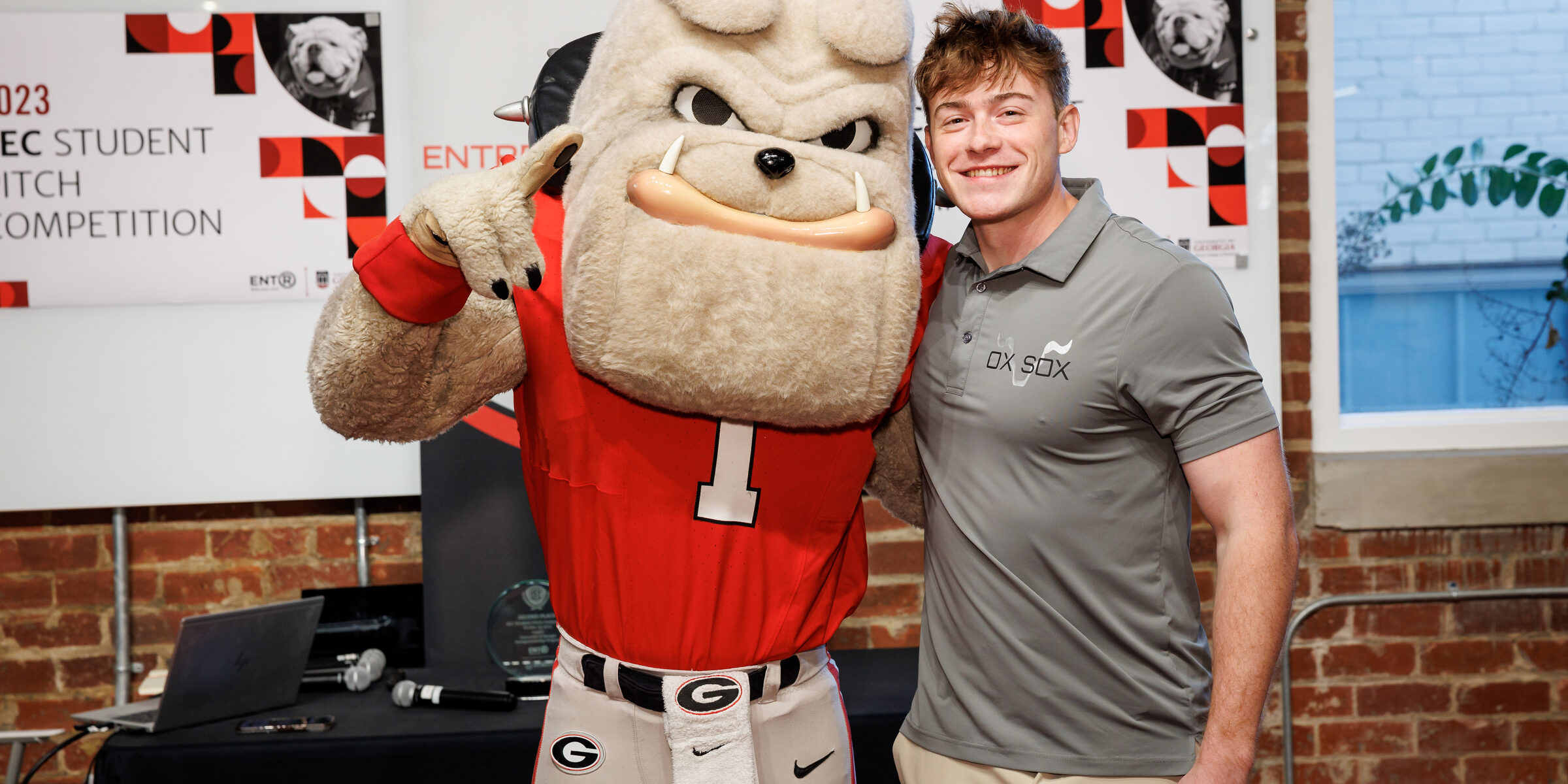 Hairy Dawg makes the number 1 sign while side-hugging Matt Tesvich at Studio 225