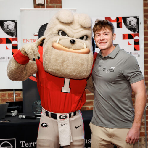 Hairy Dawg makes the number 1 sign while side-hugging Matt Tesvich at Studio 225