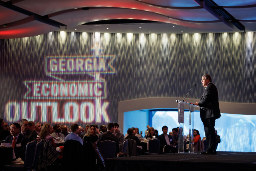 Jere Morehead presents on stage on Economic Outlook