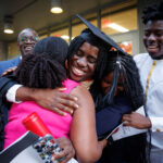 new graduate embraces family members