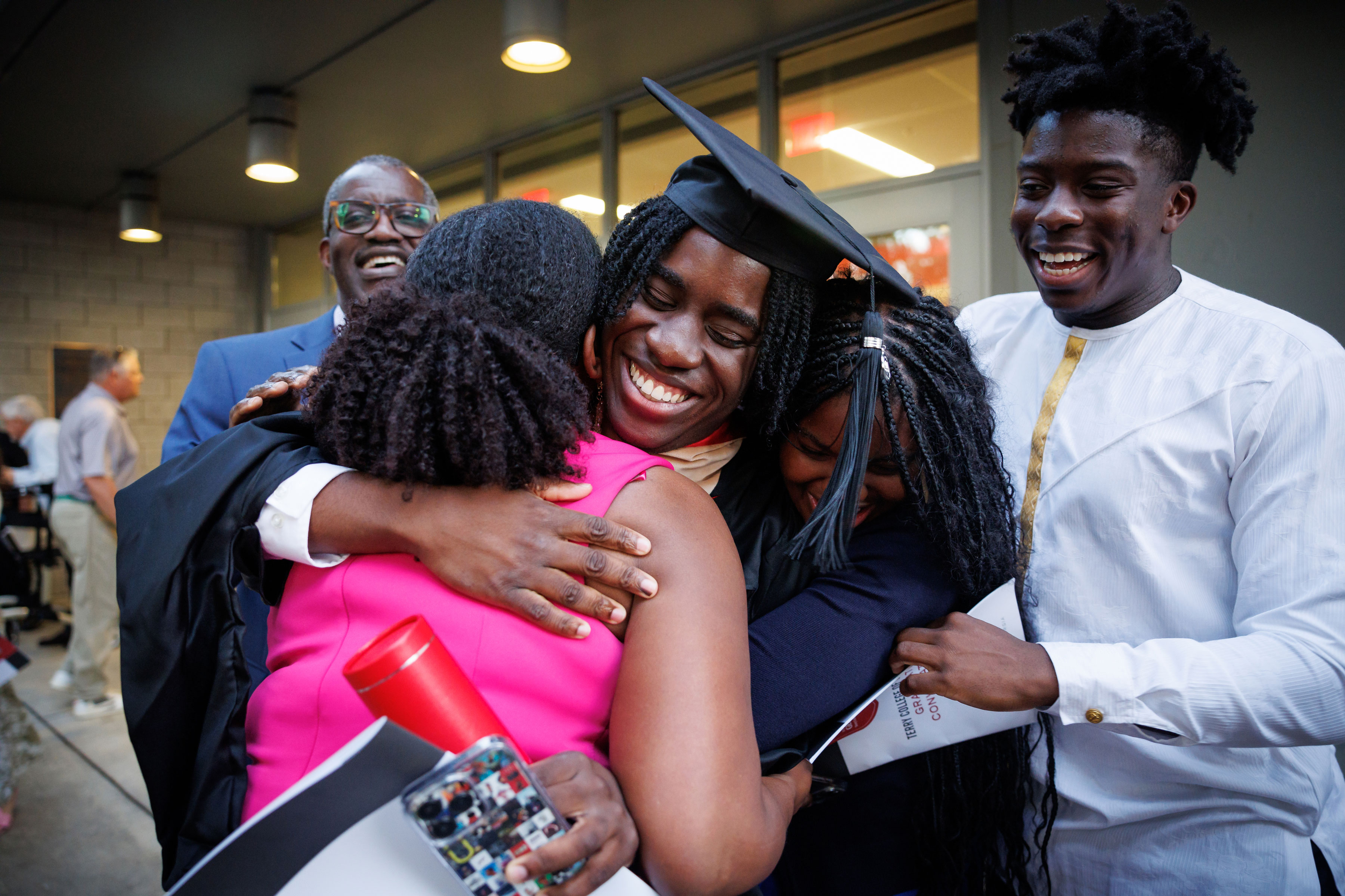 new graduate embraces family members