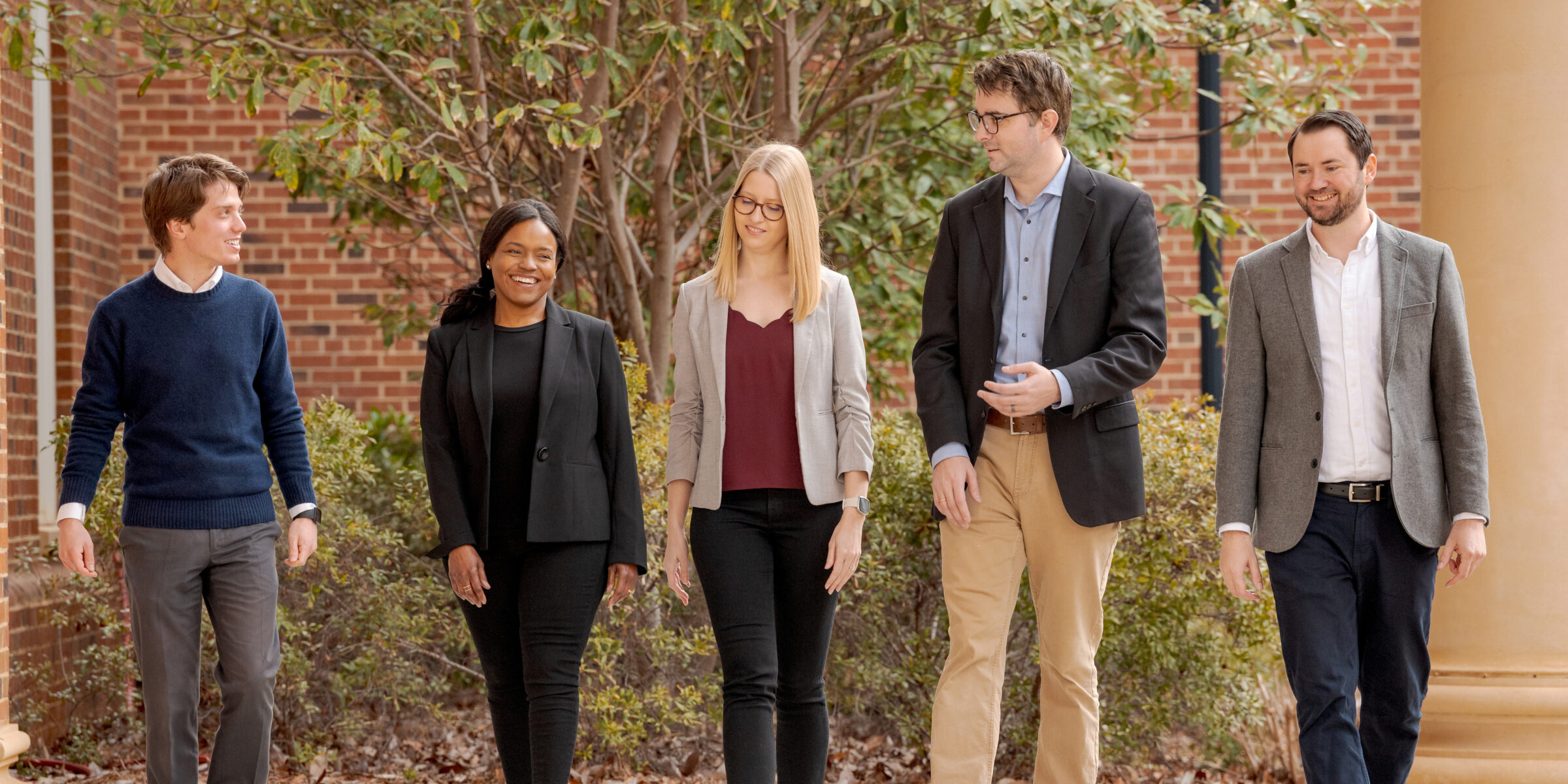 Five accounting PhD students walking and conversing