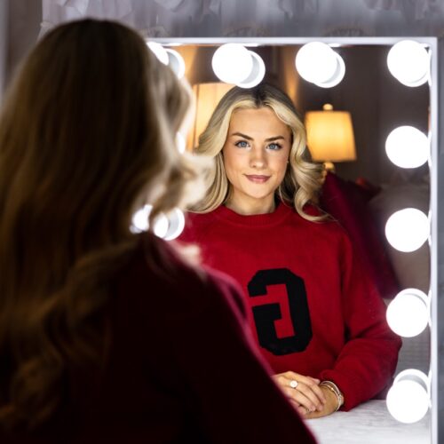 Jillian Rhae Maxwell looks in a mirror