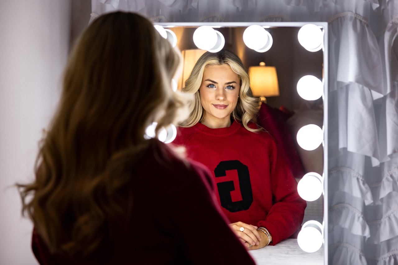 Jillian Rhae Maxwell looks in a mirror