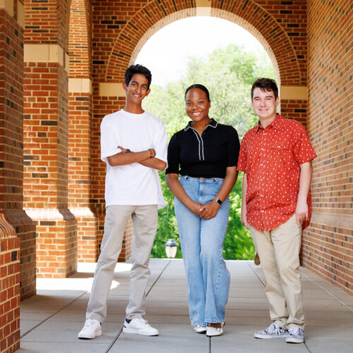 uhusuru Ranasinghe left, Anthony Tringali, right, and Lauryn Sanders, center, pose for a portrait in under and artchway in the UGA Business Learning Community.