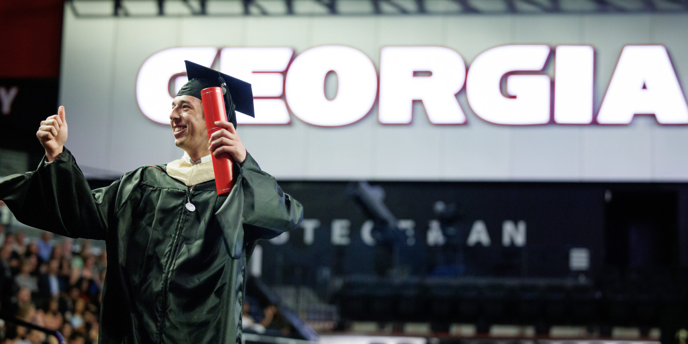 Master's graduate crossing stage at convocation ceremony
