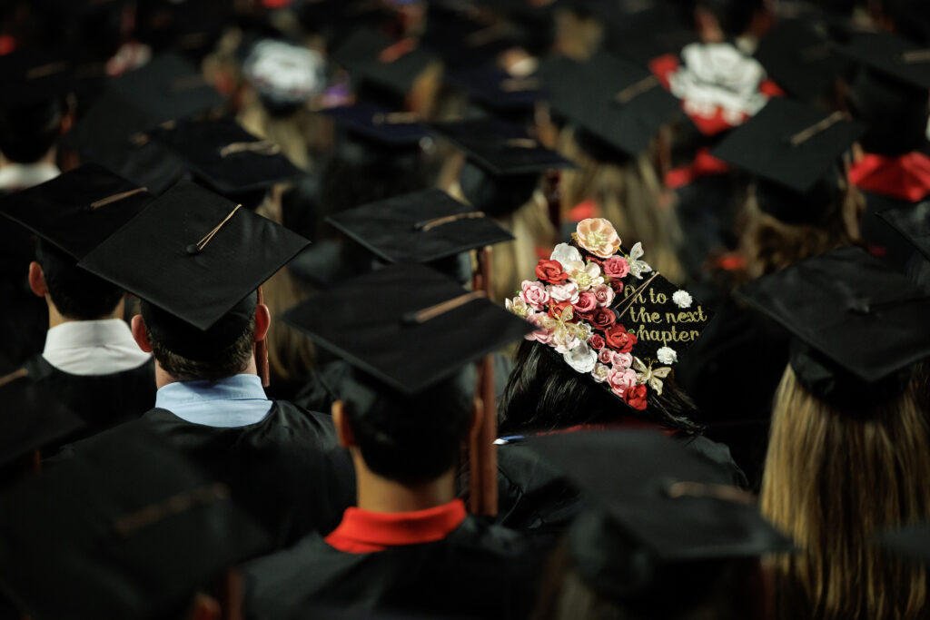 decorated graduation cap stands out among others reading "On to the next chapter"