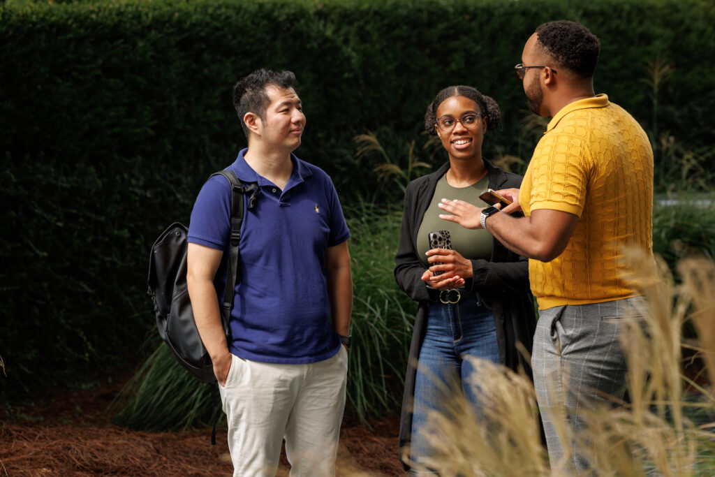 Three MPAcc students chatting with each other outside