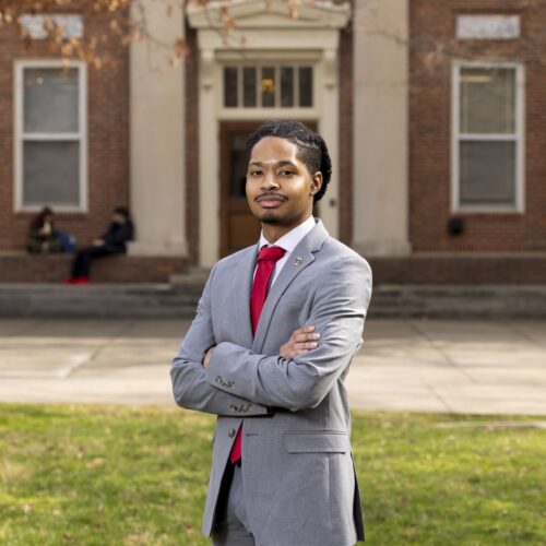 Corey Straughter Jr stands in front of a historic building on UGA's North Campus