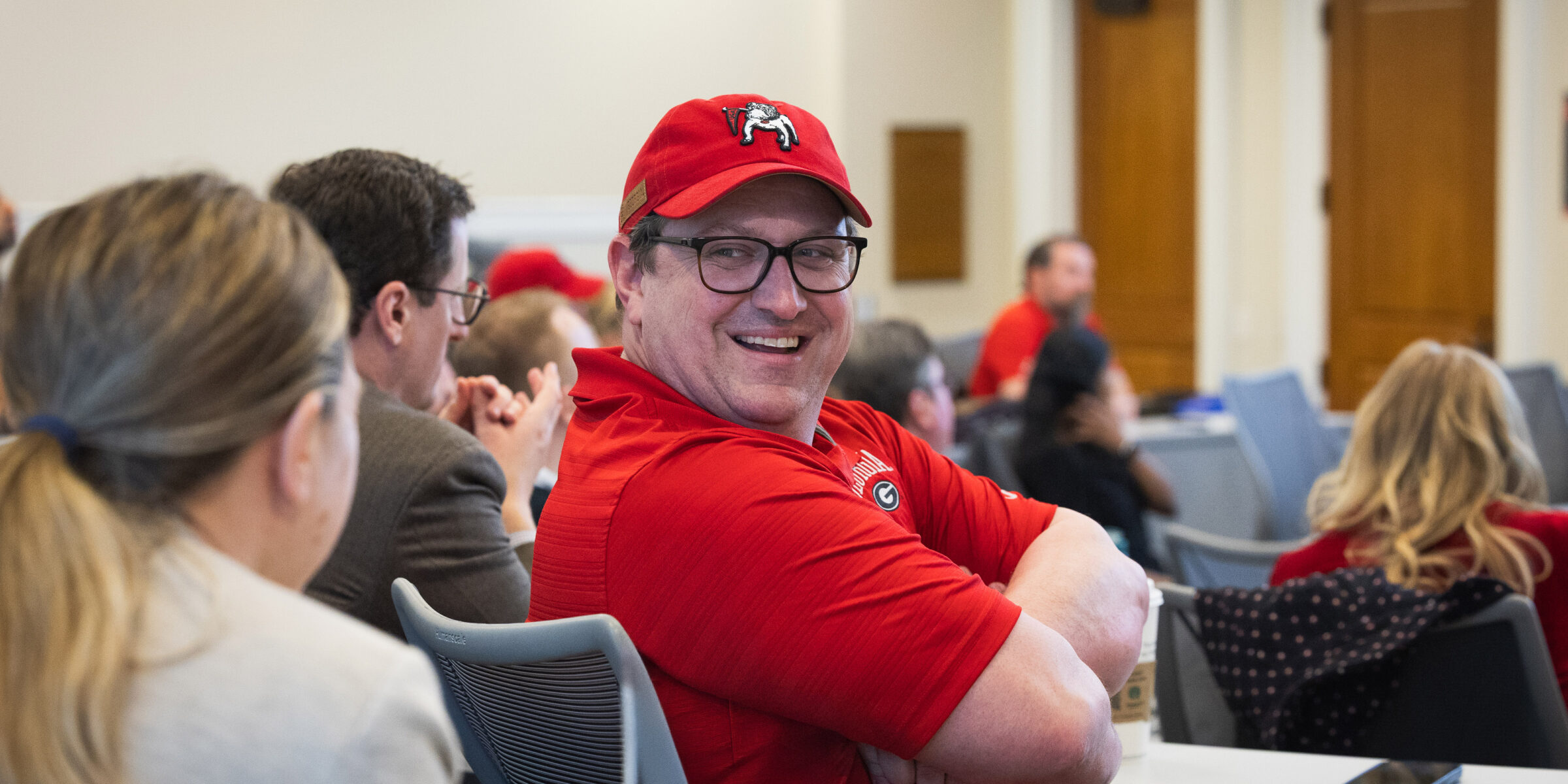 Man in red shirt having a conversation with a classmate