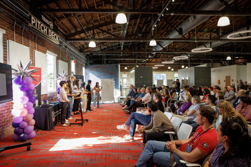 Students present their AI solutions to the crowd gathered at the immersive learning experience created and hosted by Truist. Students present their AI solutions to the crowd gathered at the immersive learning experience created and hosted by Truist.