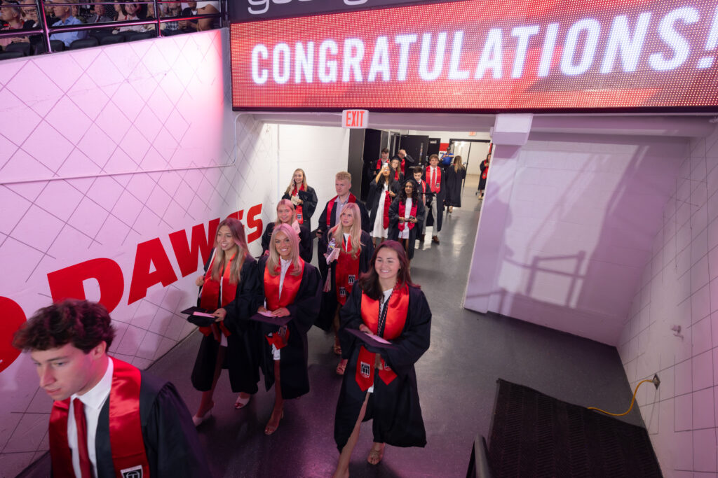 2026.05.08_rh_Undergrad_Convocation_001 Graduates flood onto the floor of Stegeman Coliseum at Terry College Undergraduate Convocation on May 8.