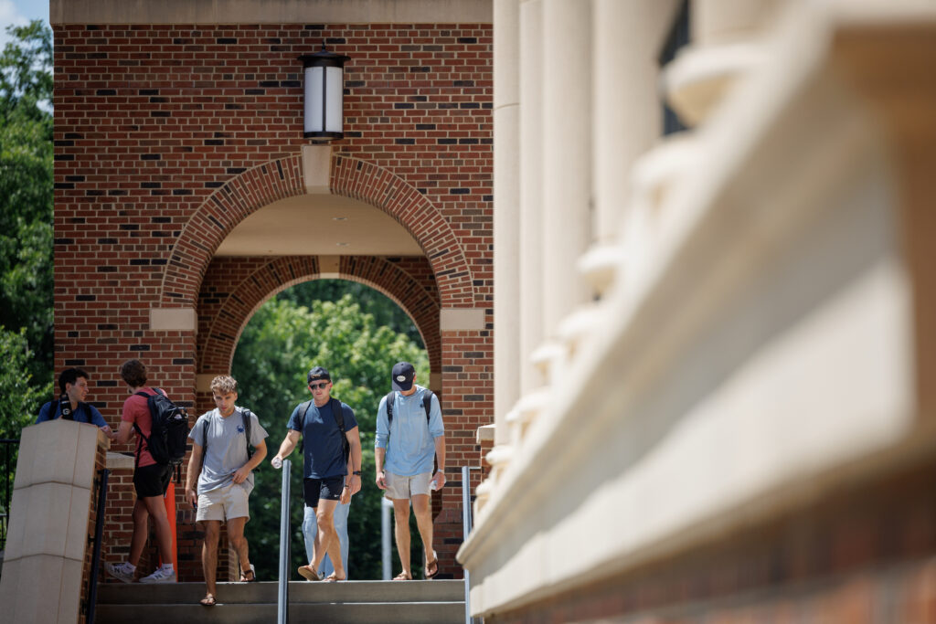 University of Georgia fall semester begins A group of young individuals walks up stone steps beneath a brick archway on a sunny day. University of Georgia fall semester beginsUniversity of Georgia fall semester begins