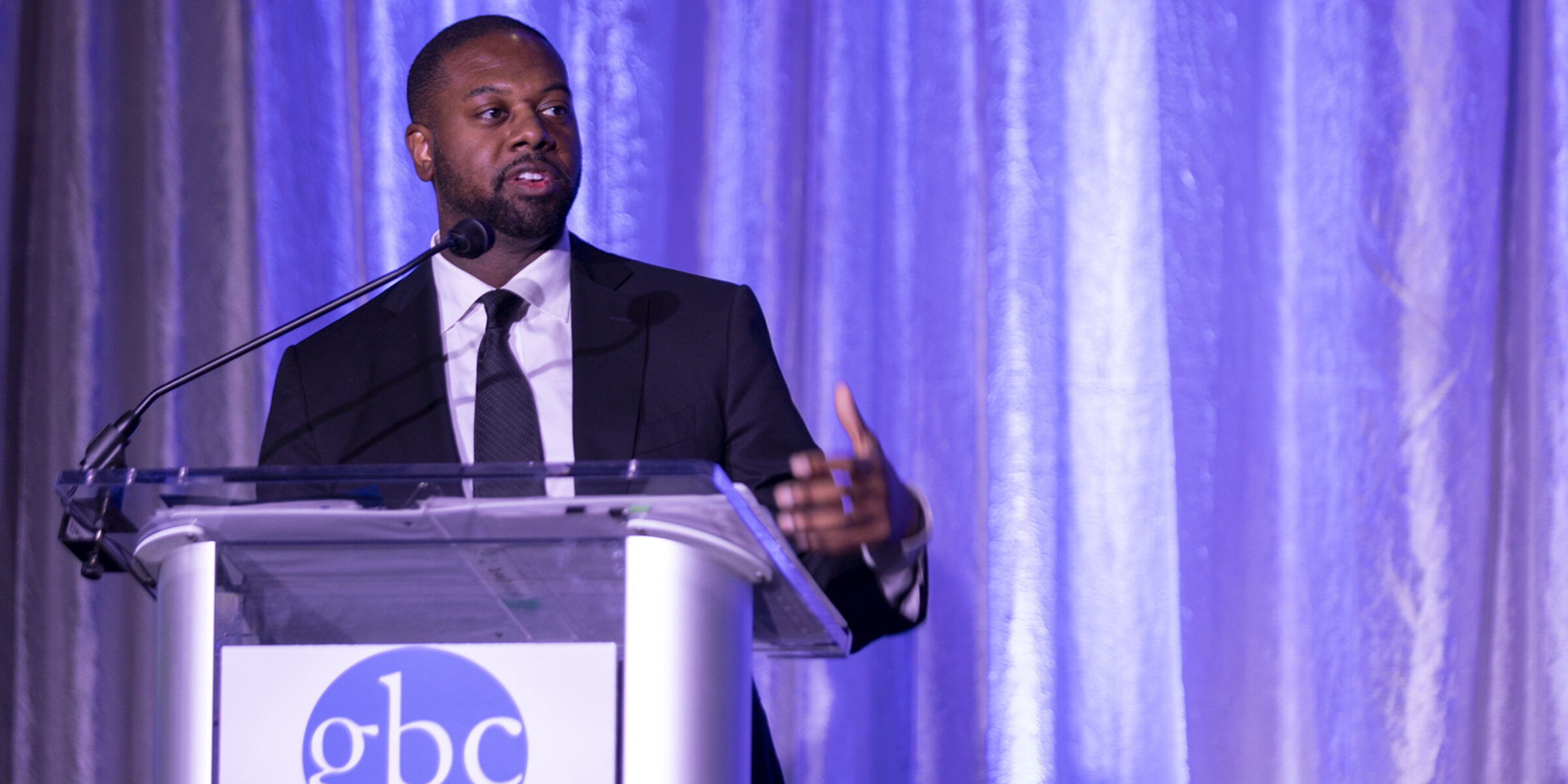 Mark Anthony Thomas speaks at a Greater Baltimore Committee podium.