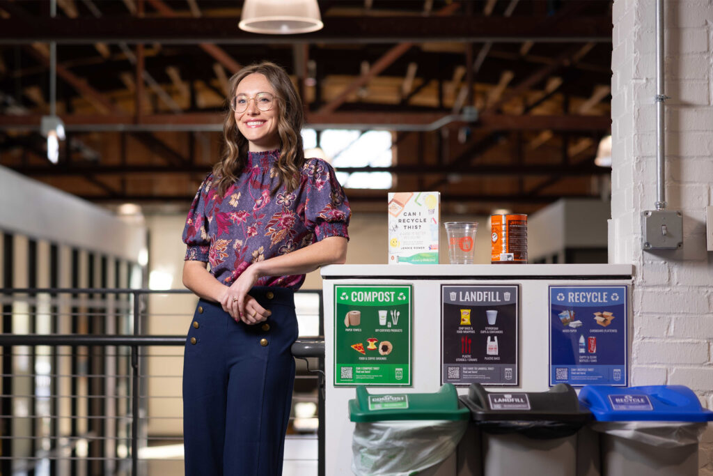 Ava Wonn poses CIRT recycling cans.