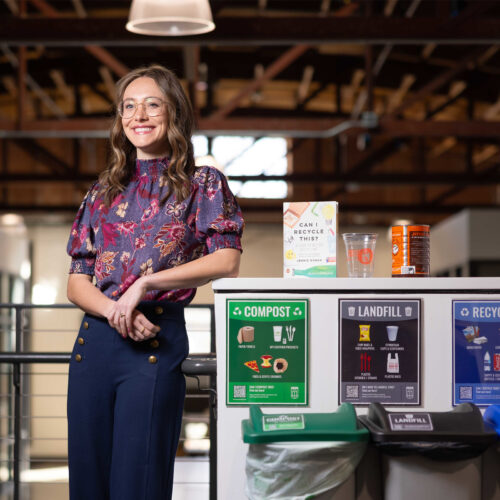 Ava Wonn poses CIRT recycling cans.