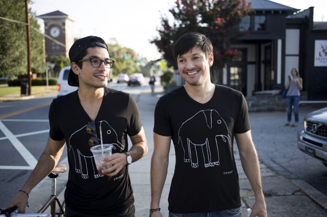 Terry graduates Alex and Jonathan Torrey walk down a street during the daytime.