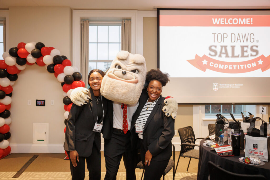 UGA Terry College sales students pose with Hairy Dawg mascot at Big Dawg Sales Competition.