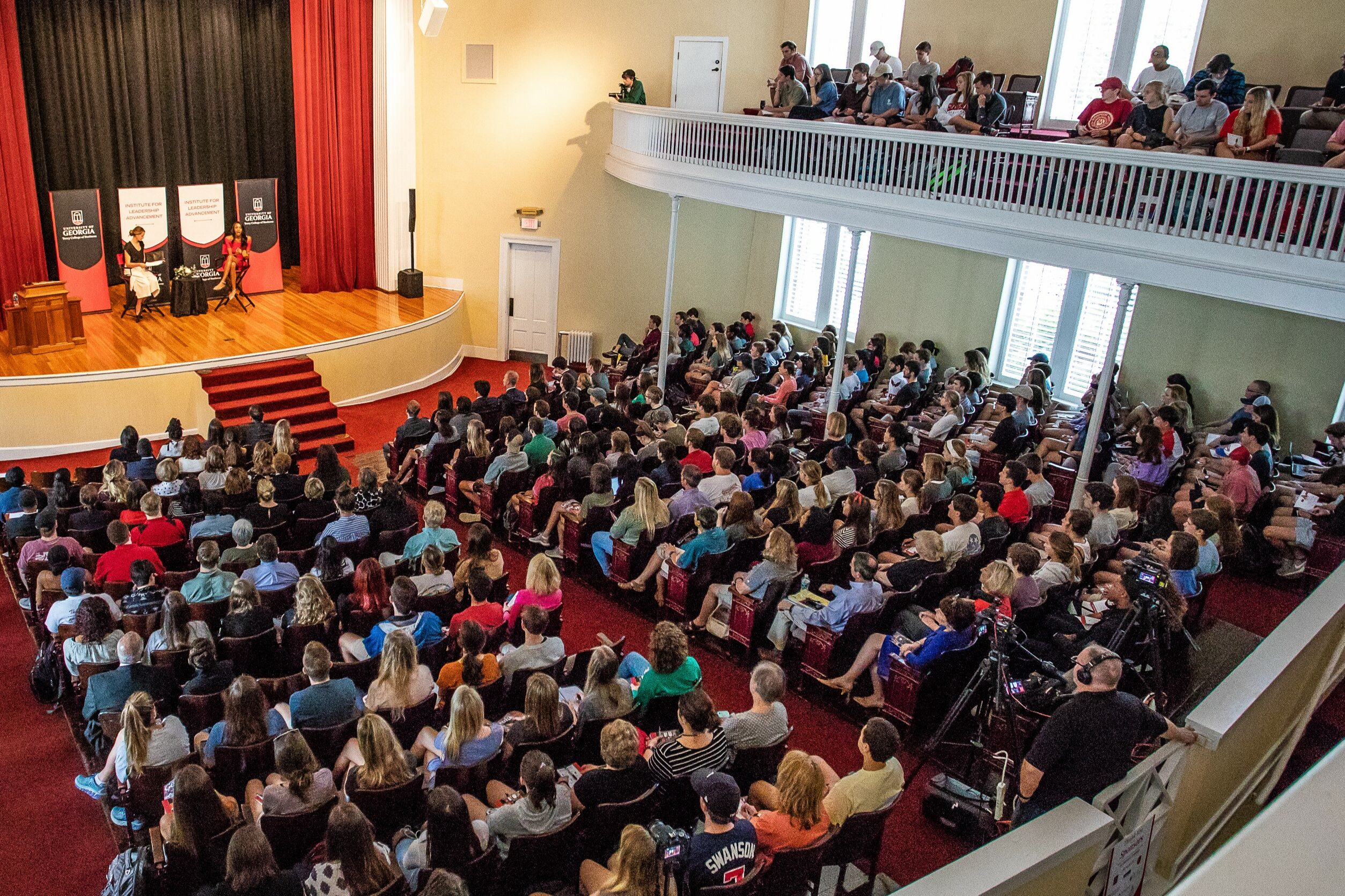 Overheadshot of a crowd of people listening to a presentation