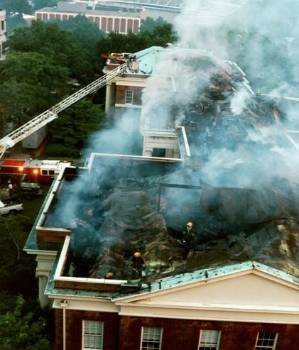 The roof of a building covered in smoke