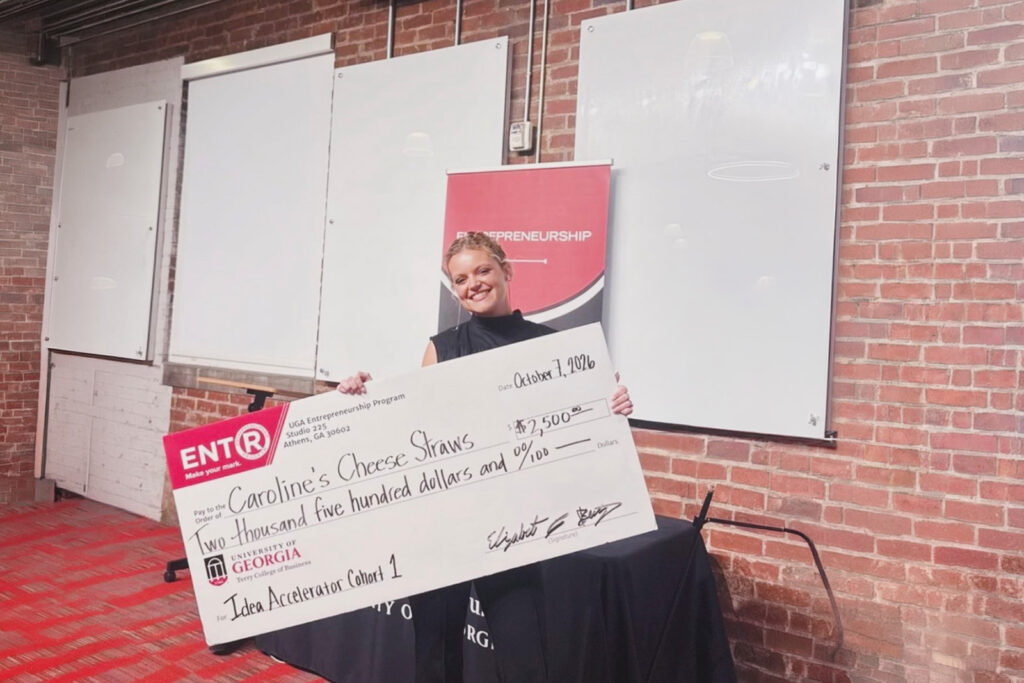 Caroline Kersey holds a large novelty check for 2500