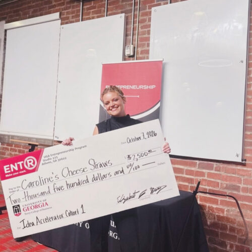 Caroline Kersey holds a large novelty check for 2500