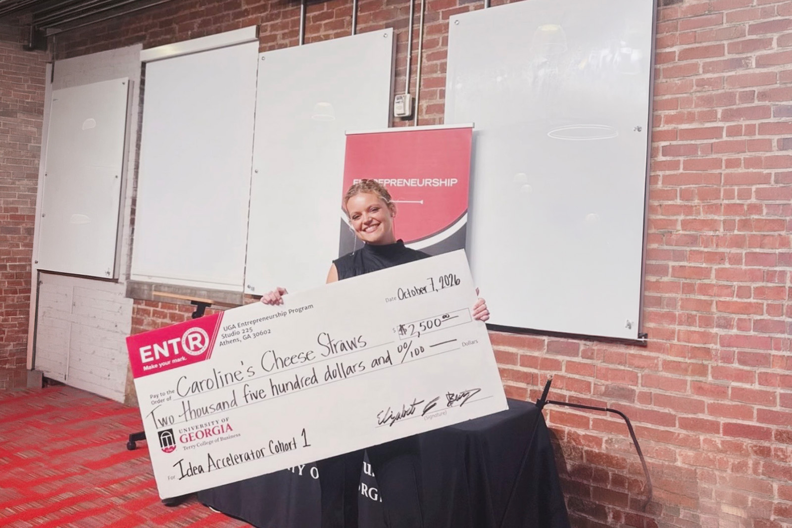 Caroline Kersey holds a large novelty check for 2500