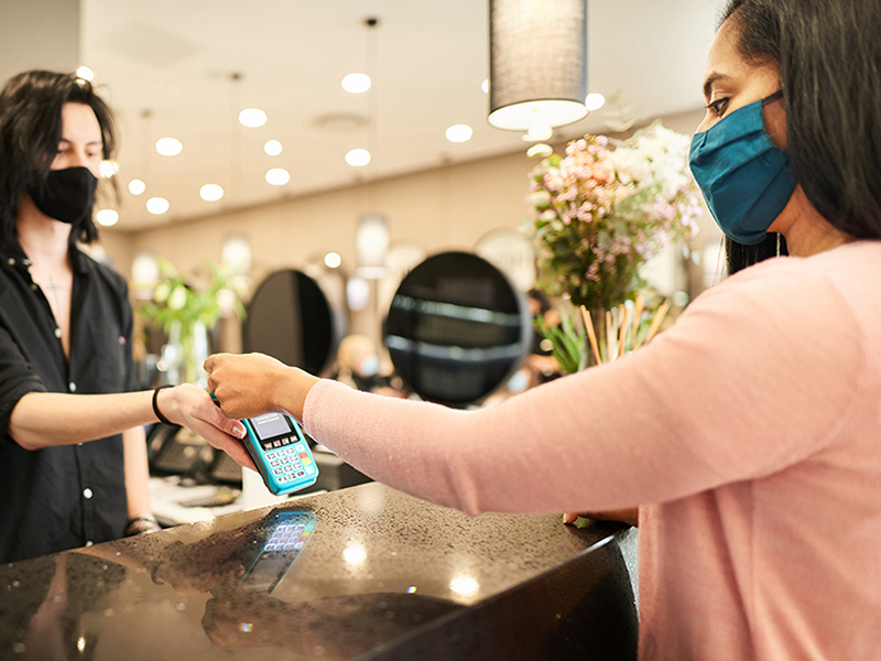 Woman paying for a product or service with a phone app