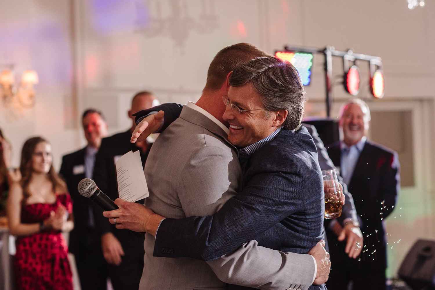 CentricsIT CEO Derek Odegard hugs a co-worker during a company ceremony.